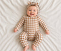 Baby wearing a brown and white gingham two-piece loungewear set with headband