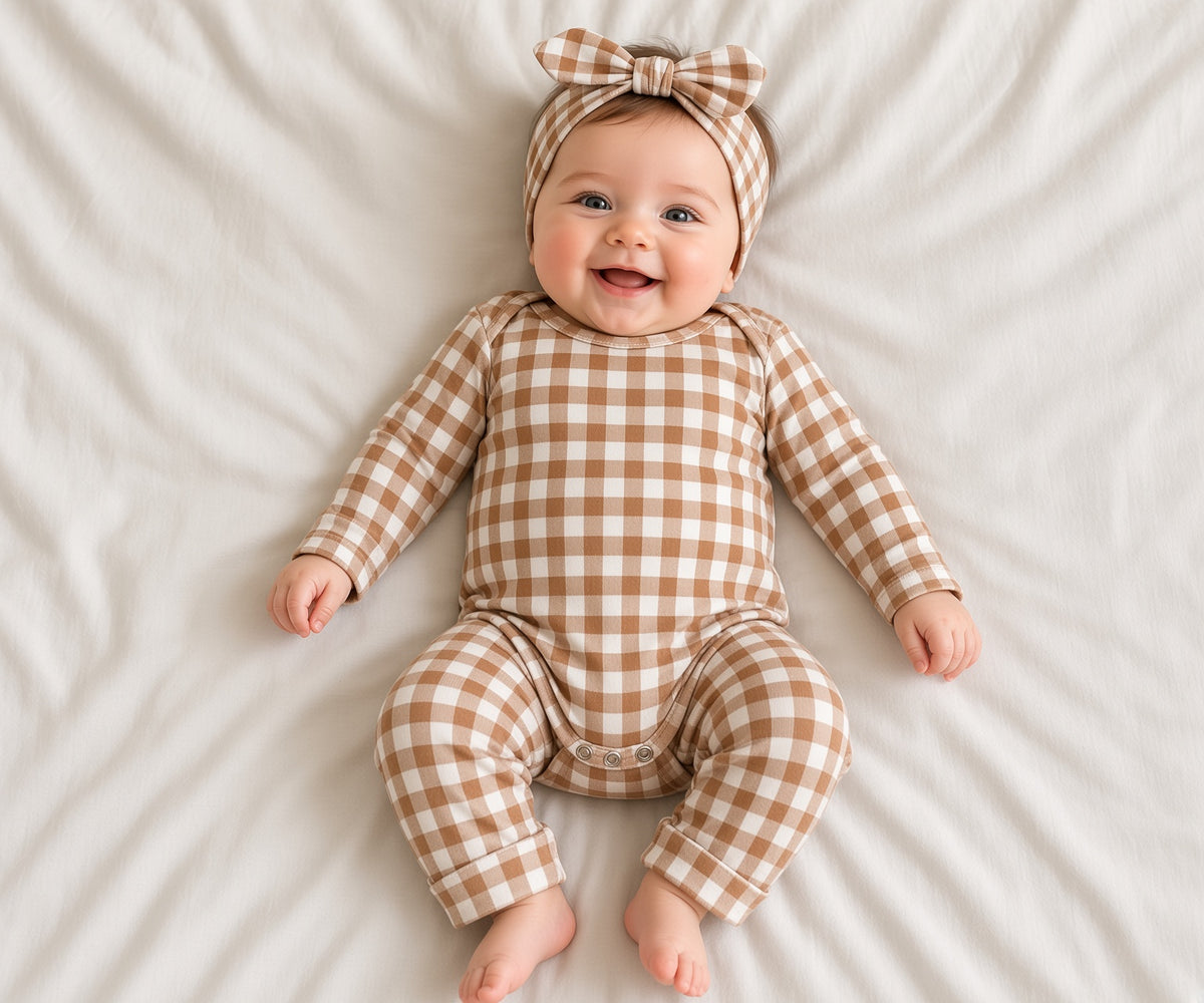 Baby wearing a brown and white gingham two-piece loungewear set with headband