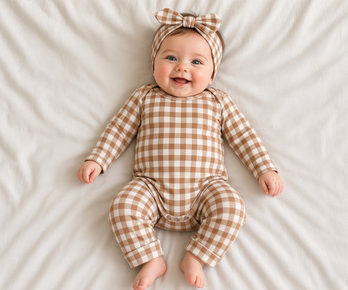 Baby wearing a brown and white gingham two-piece loungewear set with headband