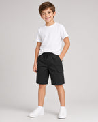 Boy wearing black Tommy Bahama twill cargo shorts with a white tee