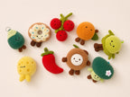 Assorted plush food keychain charms including donut, cherries, chili pepper, and cheese