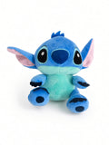 Blue alien plush toy with big ears in a sitting pose