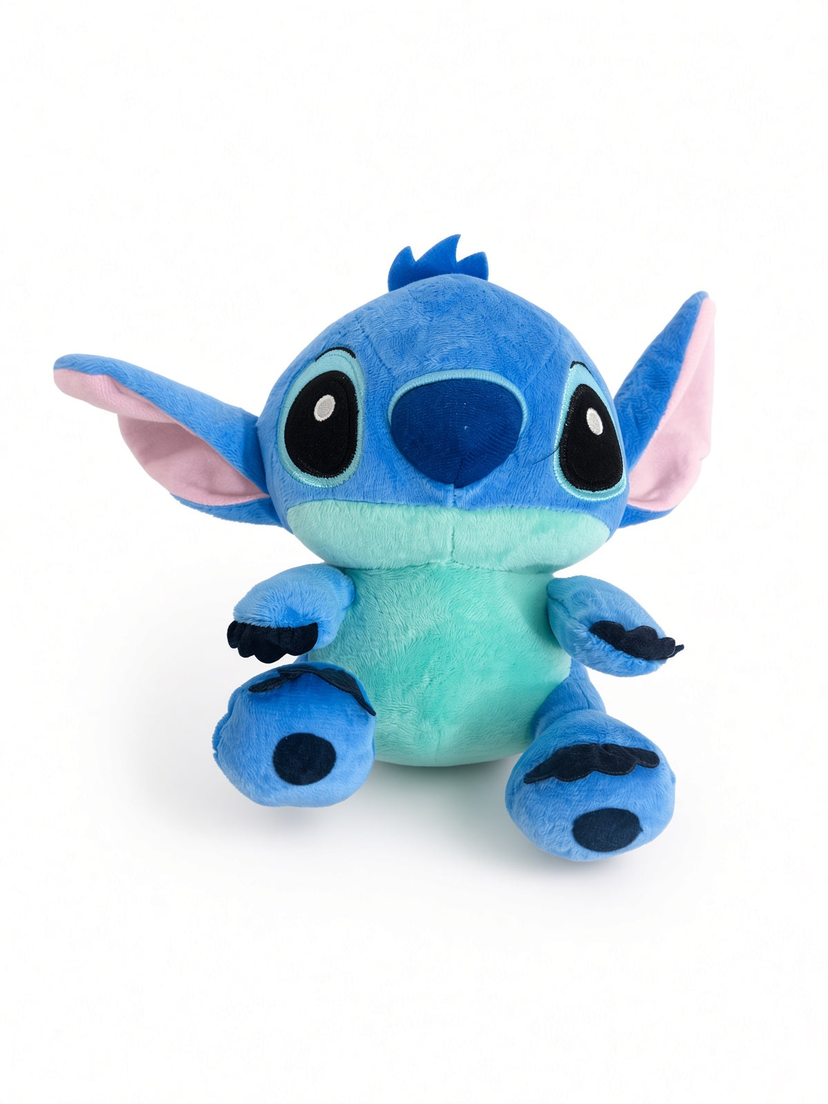 Blue alien plush toy with big ears in a sitting pose
