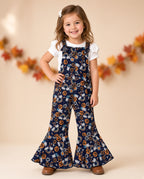 Girl wearing a navy Halloween pumpkin print bell-bottom jumpsuit with ruffle straps