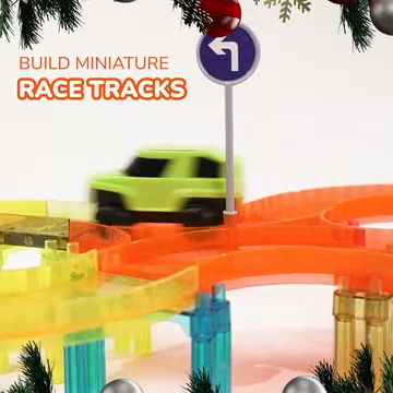 Green toy car on a PicassoTiles miniature magnetic race track next to a turn sign